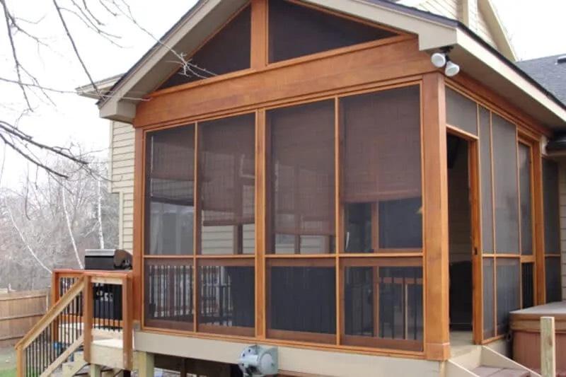 Gable end of a cedar-framed screened porch attached to a house