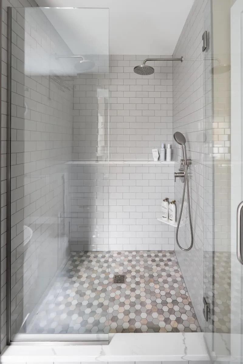 Custom double vanity with quartz countertop, undermount sinks, and wall-mounted mirrors in a Capitol Hill bathroom