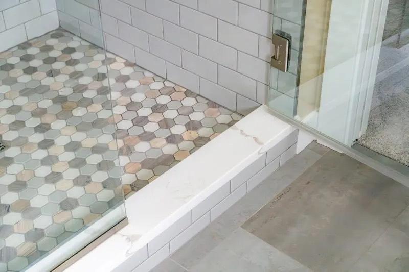 Wide view of remodeled Capitol Hill bathroom showing heated tile floor, double vanity, and open shower entry