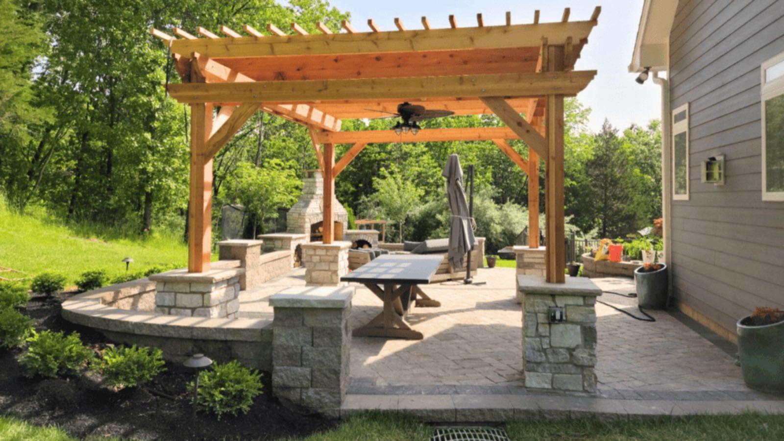 Cedar pergola over a paver patio with stone columns