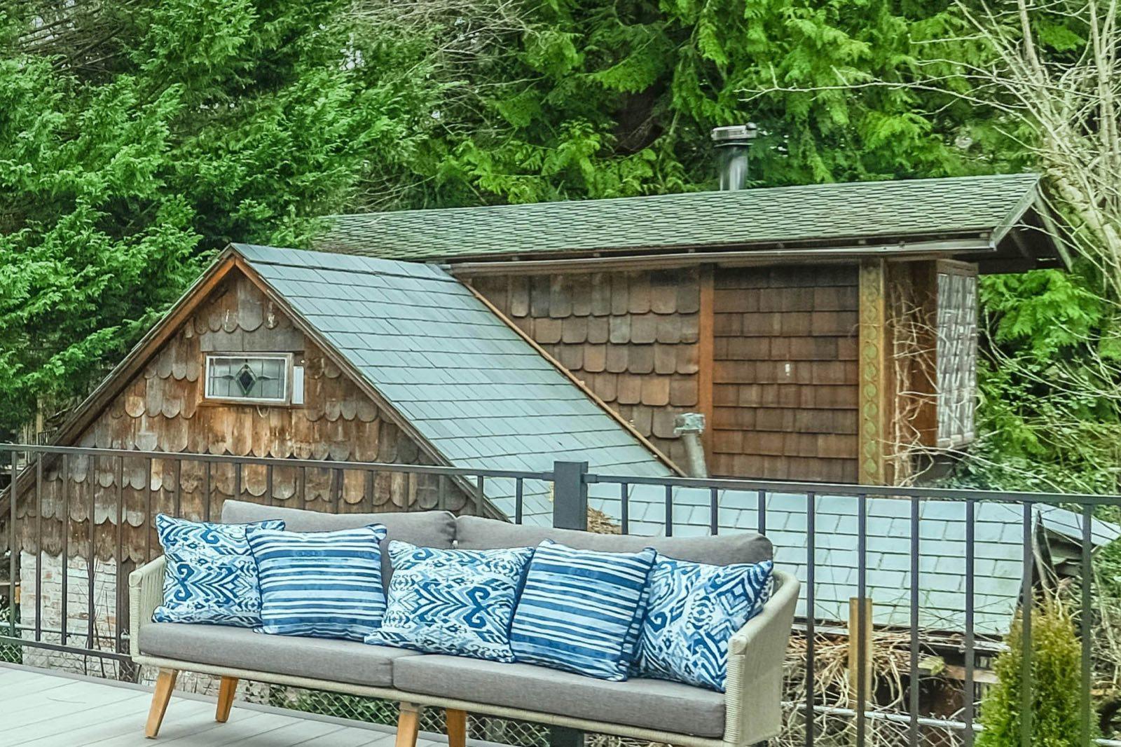Cedar-shingled backyard shed with a gable roof in a Seattle yard