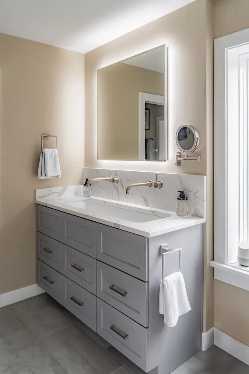 Shower interior with full-height tile surround and rainfall showerhead in the completed Capitol Hill bathroom remodel